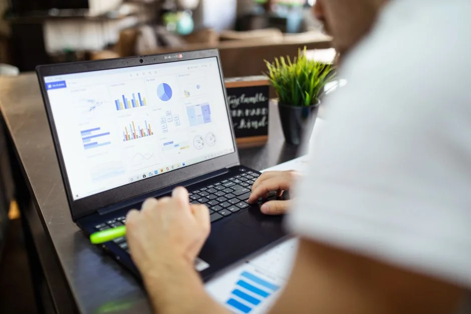 Person am Laptop betrachtet eine Auswertung mit mehreren Diagrammen