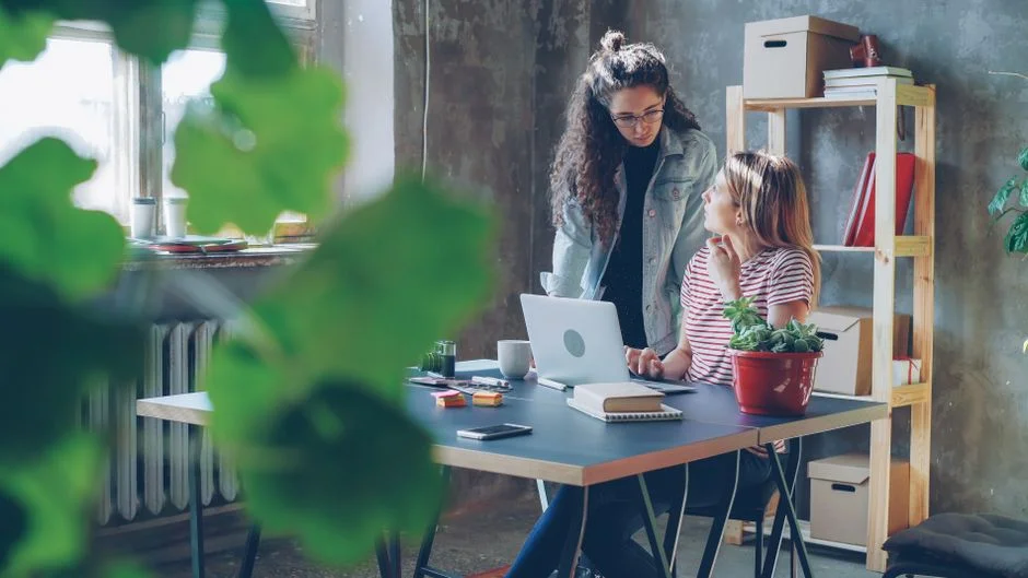 Zwei Frauen besprechen gemeinsam Inhalte am Laptop